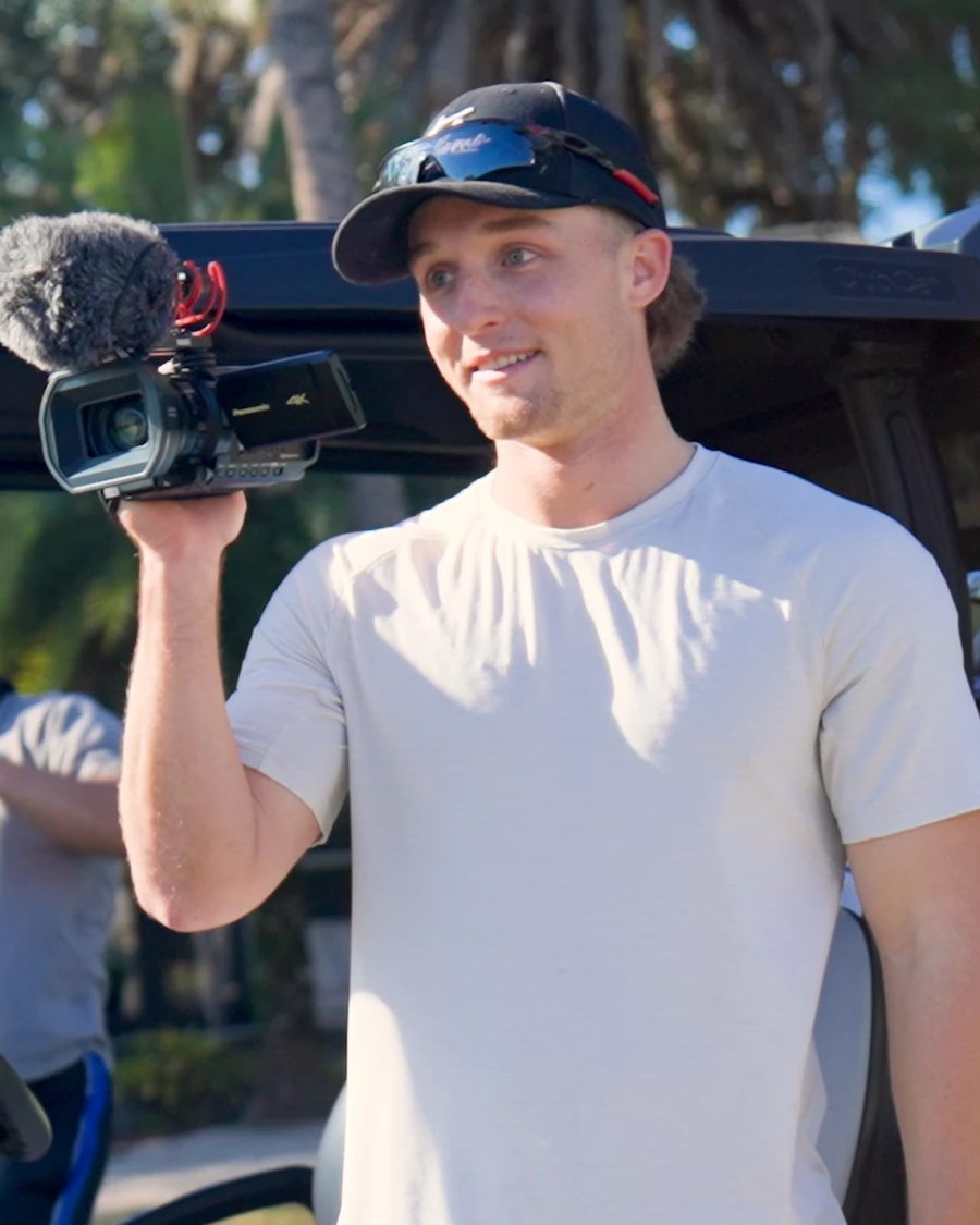Austin James holding a camera outdoors in South Florida